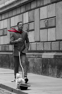 Man with dog against wall
