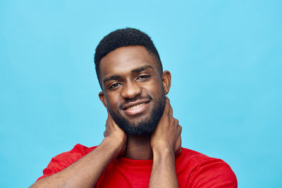 Low angle view of young man against clear blue sky