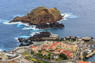 High angle view of sea and buildings in city