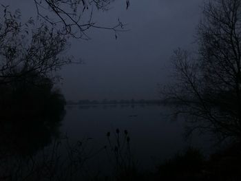 Scenic view of lake against sky during foggy weather