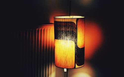 Illuminated lamp hanging on wall