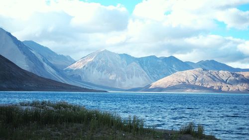 Scenic view of lake and mountains against sky