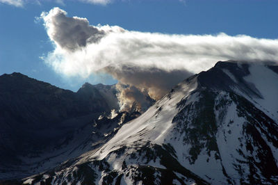 Smoke emitting from volcanic mountain against sky