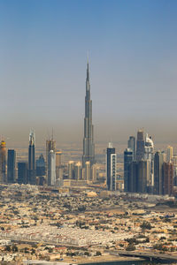 Modern buildings in city against clear sky