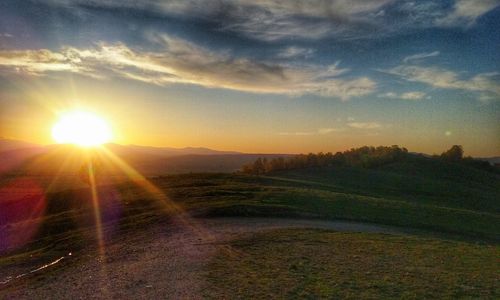 Scenic view of field against sky during sunset