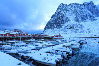 Boats moored in lake during winter