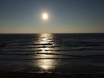 Scenic view of sea against clear sky at sunset