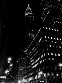 Low angle view of modern skyscraper at night