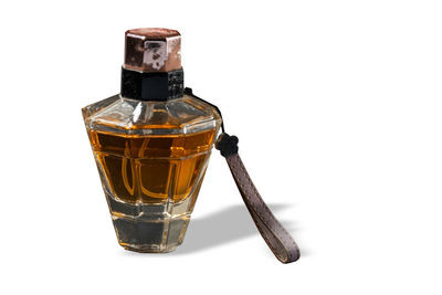 Close-up of glass bottle against white background