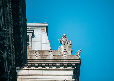 Low angle view of statue against clear blue sky