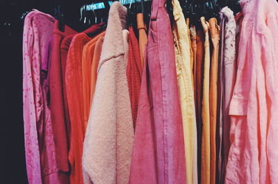 Colorful clothes hanging in closet