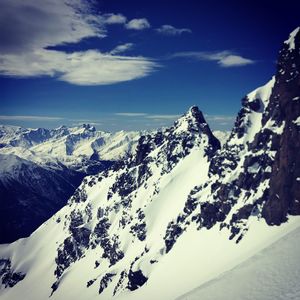 Scenic view of snow covered mountains against sky