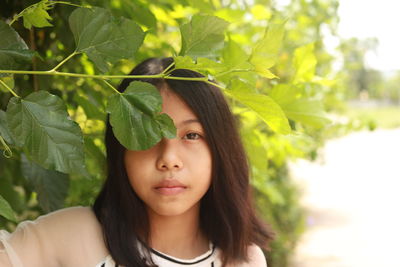 Portrait of teenage girl with leaves