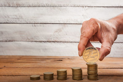 Close-up of hand holding coins