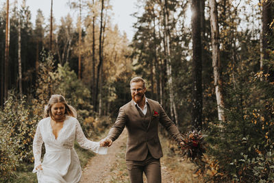 Full length of a smiling young woman in forest