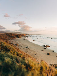 Scenic view of beach against sky during sunset