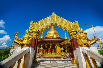 Low angle view of statue against blue sky