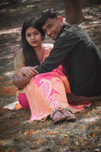 Young couple sitting outdoors