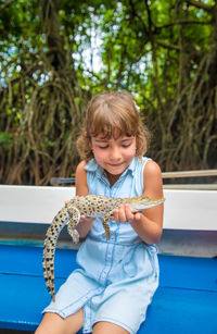 Girl holding alligator