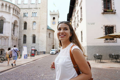 Portrait of smiling woman in city