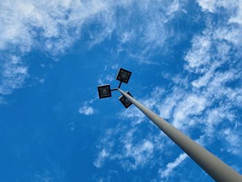 Low angle view of floodlight against blue sky