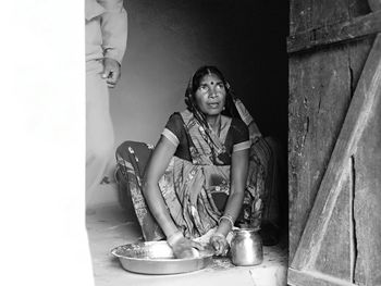 Portrait of young woman sitting at home