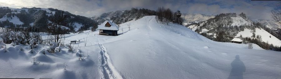Panoramic view of snow covered land and mountains