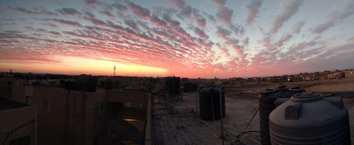 Panoramic view of buildings against sky during sunset