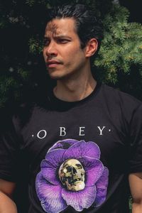 Portrait of man holding purple and tree