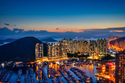 High angle view of illuminated buildings in city at dusk