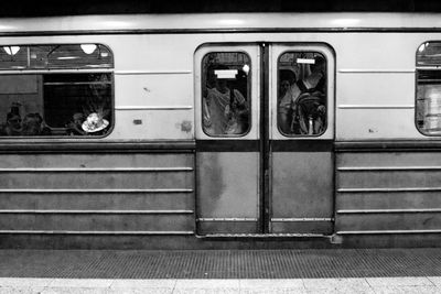 People in train seen through glass window