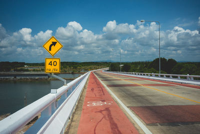 Road sign against sky