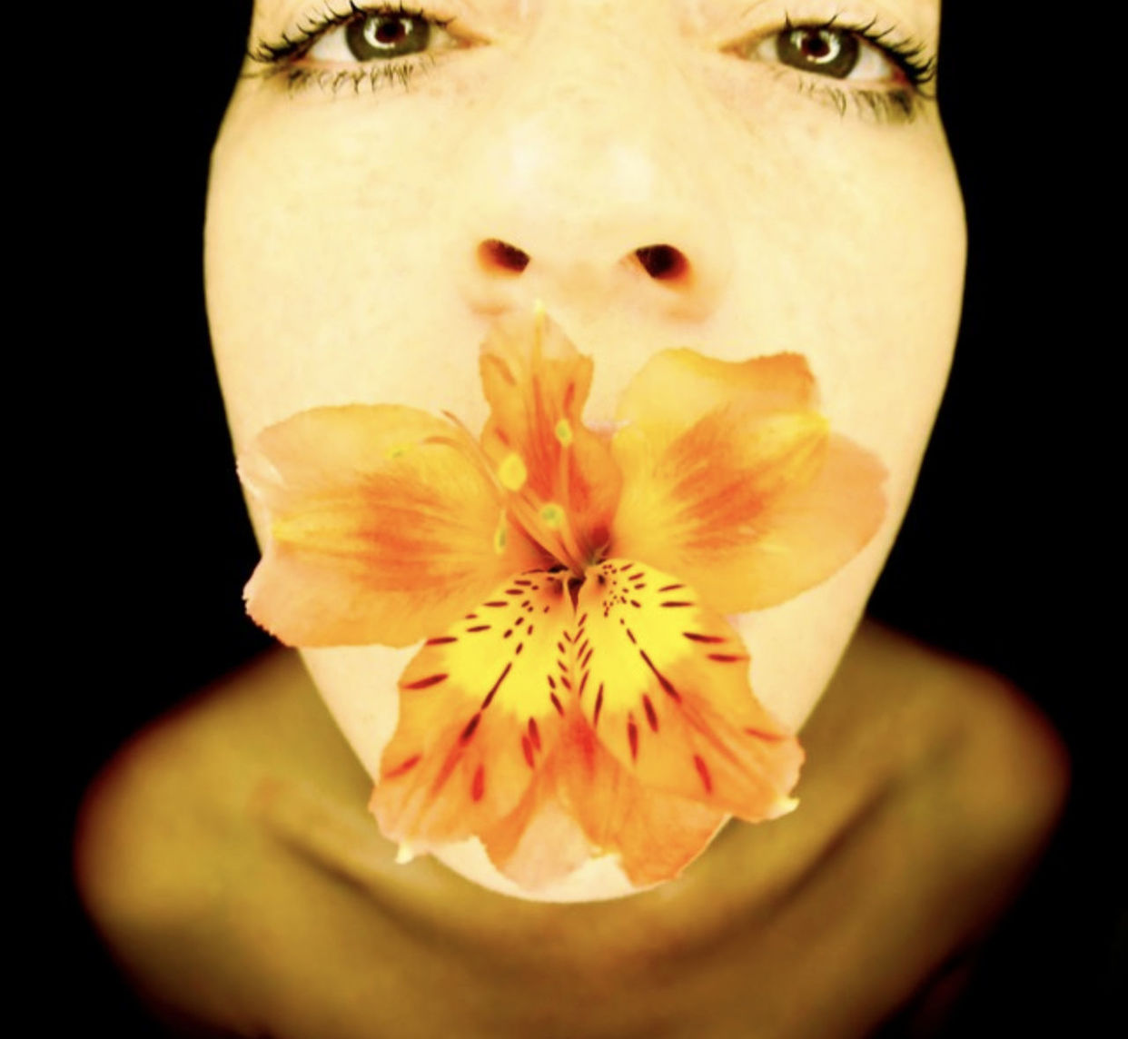 flower, close-up, one person, portrait, yellow, black background, studio shot, human head, looking at camera, flowering plant, headshot, freshness, human eye, human face, young adult, skin, indoors, beauty in nature, front view, petal, adult, plant, nose, fragility, nature, macro photography, women, human mouth