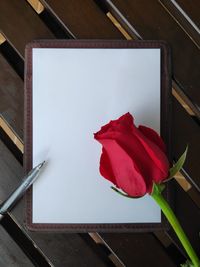 Close-up of red rose on table