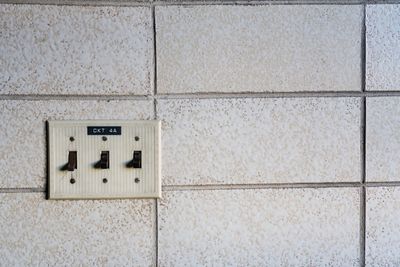 Close-up of electric lamp on wall