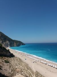 Scenic view of beach against clear blue sky