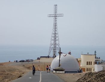 People on beach against sky
