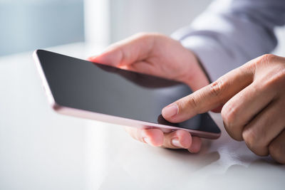 Midsection of man using mobile phone