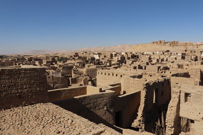 Buildings in city against clear sky