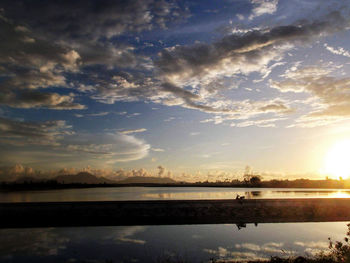 Scenic view of lake against sky at sunset