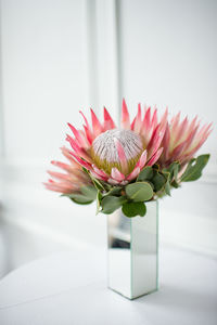 Close-up of flower vase on table at home