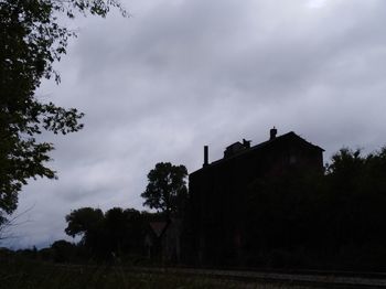 Low angle view of silhouette buildings against sky