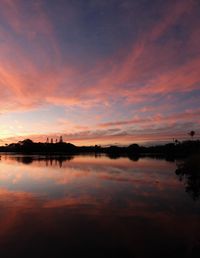 Scenic view of lake against romantic sky at sunset