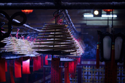 Close-up of illuminated lights hanging at market stall