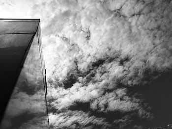 Low angle view of street light against cloudy sky