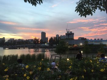 View of city at waterfront during sunset