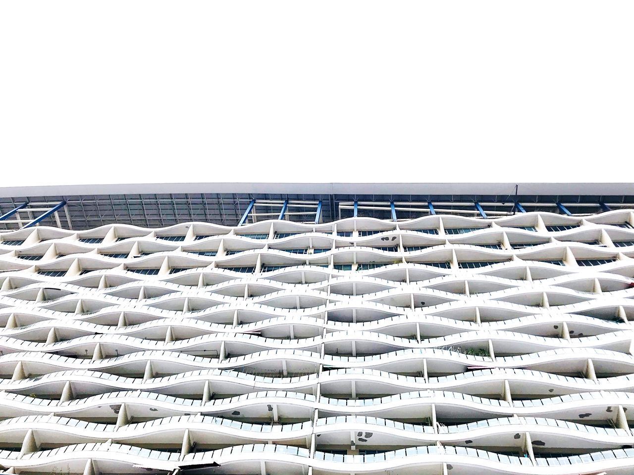 LOW ANGLE VIEW OF METALLIC BUILDING AGAINST CLEAR SKY