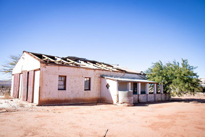 Exterior of old building against clear blue sky