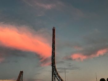 Low angle view of smoke stack against sky during sunset