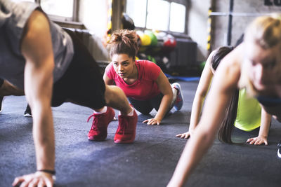 Group of young people exercising in gym